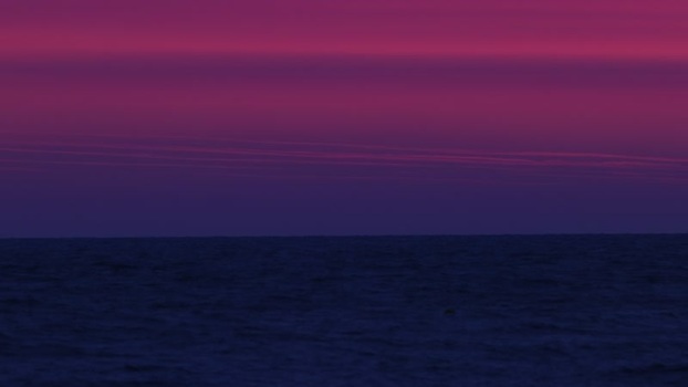View of the sea and a dramatic purple magenta sky France.