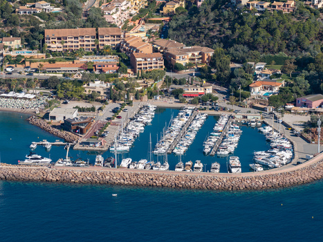 Aerial view of the marina at Le Trayas with yachts and boats docked in the harbor surrounded by coastal buildings and greenery in Saint Raphael Provence Alpes Cote d Azur France. Aerial view of the marina at Le Trayas with yachts and boats docked in the harbor surrounded by coastal buildings and greenery in Saint Raphael Provence Alpes Cote d Azur France.