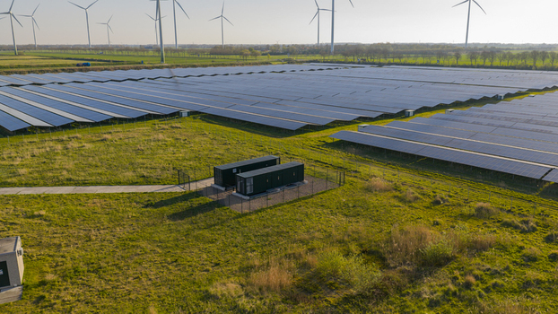 Aerial view of Solar park Delfzijl with rows of photovoltaic panels and wind turbines under a clear sky in Farmsum Groningen Netherlands. Aerial view of Solar park Delfzijl with rows of photovoltaic panels and wind turbines under a clear sky in Farmsum Groningen Netherlands.