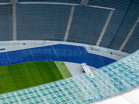 Berlin Germany 26 September 2026 Aerial view of Olympiastadion Berlin showing the blue running track green grass field and the modern glass roof structure.