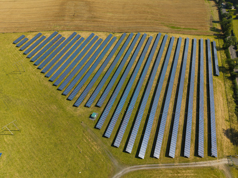 Aerial view of Lisburn Solar Farm featuring rows of photovoltaic panels arranged in a field under clear daylight Lisburn Northern Ireland United Kingdom. Aerial view of Lisburn Solar Farm featuring rows of photovoltaic panels arranged in a field under clear daylight Lisburn Northern Ireland United Kingdom.