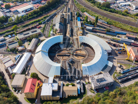Aerial view of Prague Vrsovice railway depot featuring a large circular roundhouse with multiple tracks and trains parked in the depot in Prague Prague Region Czechia.
