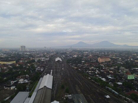 Aerial view of Stasiun Solo Balapan railway station with tracks stretching through the urban landscape of Banjarsari Central Java Indonesia. Aerial view of Stasiun Solo Balapan railway station with tracks stretching through the urban landscape of Banjarsari Central Java Indonesia.