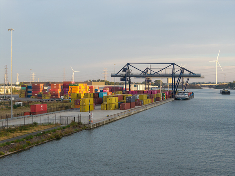 Genk Vlaanderen Belgium 27 August 2026 Aerial view of the Haven Genk container terminal with stacked shipping containers a gantry crane and a cargo barge. Genk Vlaanderen Belgium 27 August 2026 Aerial view of the Haven Genk container terminal with stacked shipping containers a gantry crane and a cargo barge.