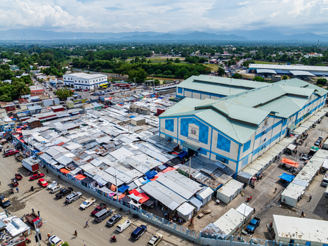 Aerial view of Mercado Binacional Dajabon with its dense collection of market stalls metal roofs and surrounding vehicles in Dajabon Dajabon Dominican Republic. Aerial view of Mercado Binacional Dajabon with its dense collection of market stalls metal roofs and surrounding vehicles in Dajabon Dajabon Dominican Republic.