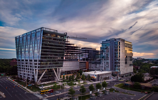 Reston Virginia United States 27 May 2020 Aerial view of modern office buildings and mixed use developments in Reston Town Center under a dramatic sunset sky. Reston Virginia United States 27 May 2020 Aerial view of modern office buildings and mixed use developments in Reston Town Center under a dramatic sunset sky.