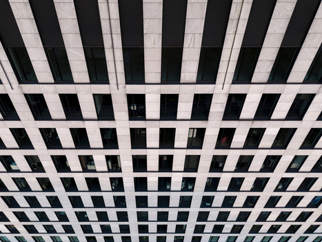 Aerial view of the modern grid facade of a building with stone textures and glass windows in Krakow Lesser Poland Voivode Poland. Aerial view of the modern grid facade of a building with stone textures and glass windows in Krakow Lesser Poland Voivode Poland.
