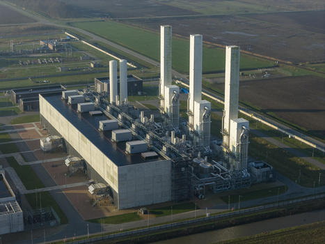 Aerial view of the Nitrogen plant featuring tall white exhaust stacks and complex industrial piping systems surrounded by green fields in Zuidbroek Groningen Netherlands. Aerial view of the Nitrogen plant featuring tall white exhaust stacks and complex industrial piping systems surrounded by green fields in Zuidbroek Groningen Netherlands.
