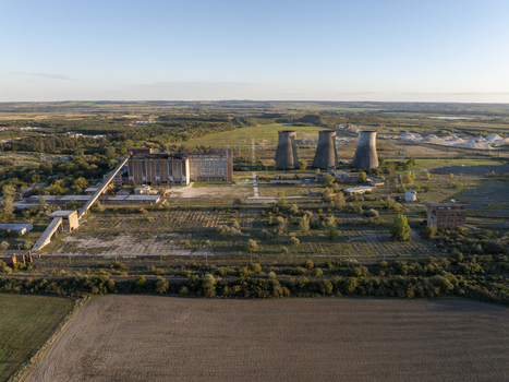 Aerial view of the abandoned Inota Power Plant with its iconic cooling towers industrial buildings and surrounding fields in Varpalota Hungary. Aerial view of the abandoned Inota Power Plant with its iconic cooling towers industrial buildings and surrounding fields in Varpalota Hungary.