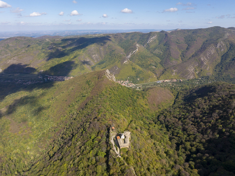 Aerial view of Glozhene Monastery perched on a mountain ridge surrounded by dense forests and rolling hills in Lovech Bulgaria.