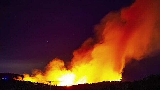 View of a wildfire burning at night in Spain.