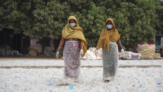 View of women working in a plastic recycling facility Bangladesh. View of women working in a plastic recycling facility Bangladesh.