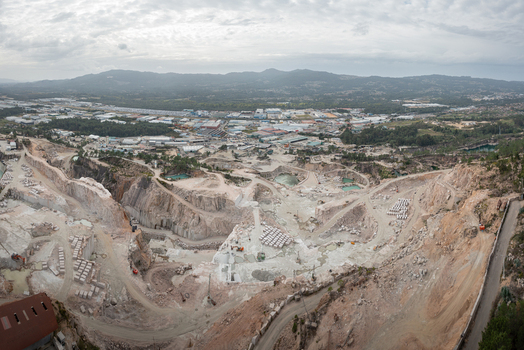 Aerial view of Cantera Porrino granite quarry with excavated stone pits industrial machinery and surrounding landscape in O Porrino Pontevedra Spain. Aerial view of Cantera Porrino granite quarry with excavated stone pits industrial machinery and surrounding landscape in O Porrino Pontevedra Spain.