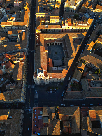 Aerial view of San Nicolo l Arena Benedictine Monastery with its large courtyard and terracotta rooftops during golden hour in Catania Sicily Italy. Aerial view of San Nicolo l Arena Benedictine Monastery with its large courtyard and terracotta rooftops during golden hour in Catania Sicily Italy.