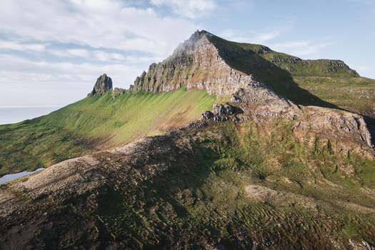 Aerial view of Hornstrandir Nature Reserve featuring sharp mountain peaks steep grassy slopes and rocky ridges in Isafjordur Isafjardarbaer Iceland. Aerial view of Hornstrandir Nature Reserve featuring sharp mountain peaks steep grassy slopes and rocky ridges in Isafjordur Isafjardarbaer Iceland.