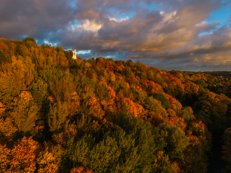 Aerial view of the Three Crosses Monument standing atop a hill dressed in vibrant autumn colors under a dramatic sky Vilnius Lithuania. Aerial view of the Three Crosses Monument standing atop a hill dressed in vibrant autumn colors under a dramatic sky Vilnius Lithuania.