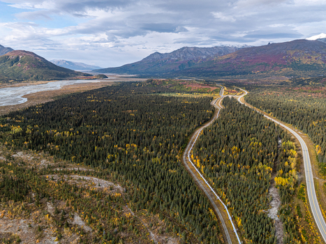 Aerial view of the Delta River winding through the boreal forest with the Trans Alaska Pipeline running alongside the highway in Southeast Fairbanks Alaska United States. Aerial view of the Delta River winding through the boreal forest with the Trans Alaska Pipeline running alongside the highway in Southeast Fairbanks Alaska United States.