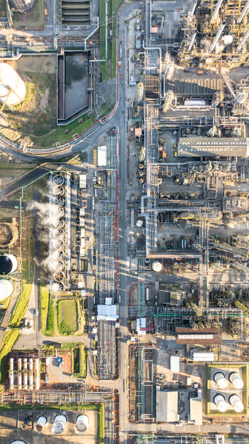 Aerial view of the petrochemical complex in Santo Andre featuring industrial infrastructure cooling towers with steam storage tanks and pipe networks in Santo Andre State of Sao Paulo Brazil.