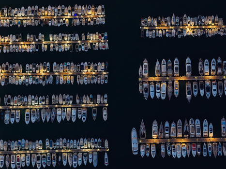 Aerial view of numerous yachts and boats docked in the marina at night with illuminated piers in Antibes Provence Alpes Cote d Azur France. Aerial view of numerous yachts and boats docked in the marina at night with illuminated piers in Antibes Provence Alpes Cote d Azur France.