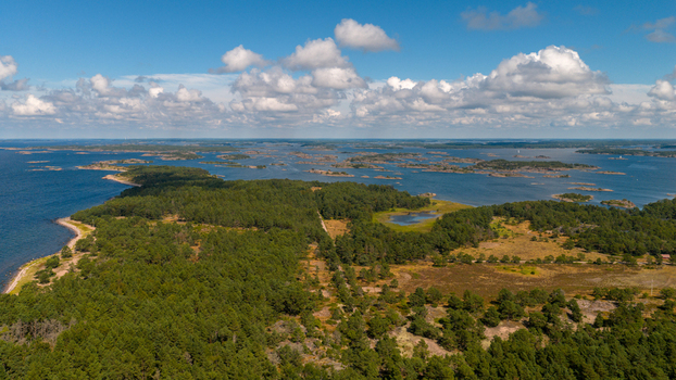 Aerial view of Oro Fortress Island surrounded by dense pine forests and the rocky coastline of the Baltic Sea in Oro Varsinais Suomi Finland. Aerial view of Oro Fortress Island surrounded by dense pine forests and the rocky coastline of the Baltic Sea in Oro Varsinais Suomi Finland.