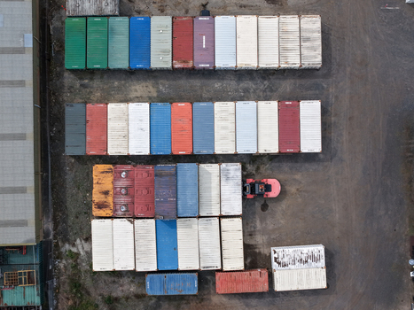Melbourne Australia 25 September 2026 Aerial view of rows of colorful shipping containers arranged in a storage yard with a forklift operating nearby.