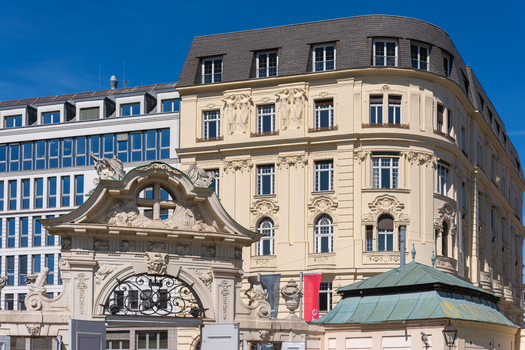 View of the ornate facade and sculptures of the Belvedere Palace complex under a clear blue sky in Vienna Vienna Austria. View of the ornate facade and sculptures of the Belvedere Palace complex under a clear blue sky in Vienna Vienna Austria.