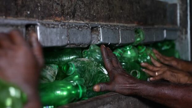 View of workers sorting green plastic bottles in Bogura Bangladesh. View of workers sorting green plastic bottles in Bogura Bangladesh.