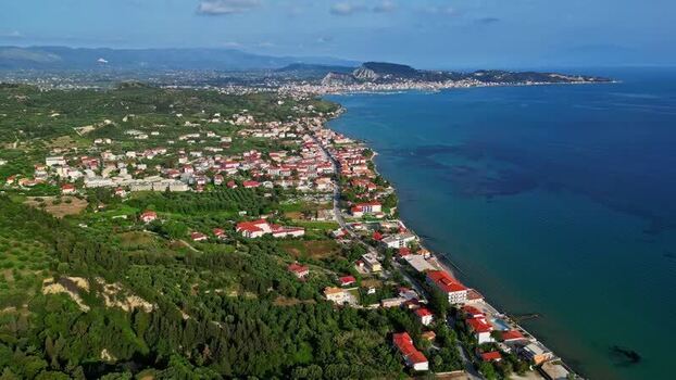 Aerial view of coastal town with red roofed houses Greece.