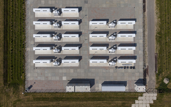 Aerial view of the Battery Energy Storage System at Wind Park featuring rows of white storage containers on a paved site in Dronten Flevoland Netherlands. Aerial view of the Battery Energy Storage System at Wind Park featuring rows of white storage containers on a paved site in Dronten Flevoland Netherlands.