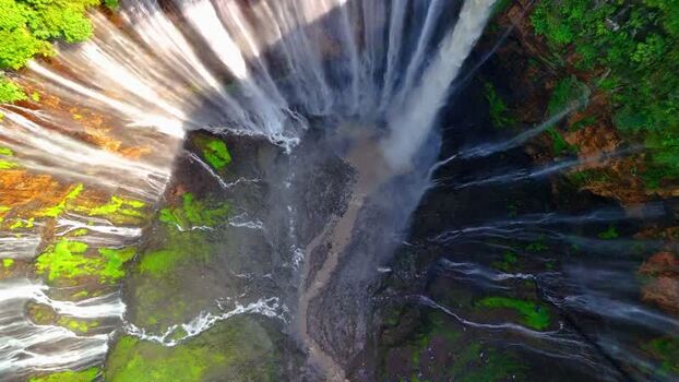 Aerial view of Tumpak Sewu Waterfall falling into a canyon Indonesia.