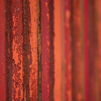 View of layered rust and faded orange paint create a textured and weathered industrial surface with a sense of decay and history Dronten Netherlands. View of layered rust and faded orange paint create a textured and weathered industrial surface with a sense of decay and history Dronten Netherlands.