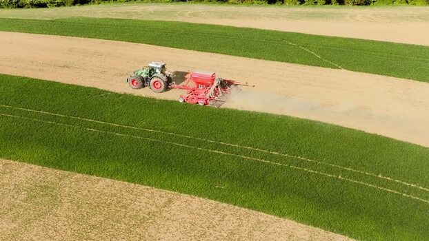 Aerial view of a tractor sowing seeds in a field Czechia. Aerial view of a tractor sowing seeds in a field Czechia.