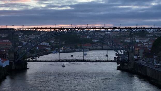 Aerial view of people walking Dom Luís I Bridge at sunset Portugal. Aerial view of people walking Dom Luís I Bridge at sunset Portugal.