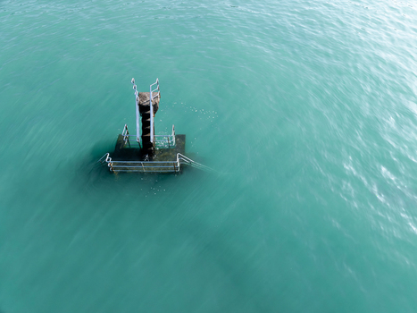 Aerial view of a solitary platform with ladder standing sentinel amidst the turquoise embrace of the sea Saint Malo Brittany France. Aerial view of a solitary platform with ladder standing sentinel amidst the turquoise embrace of the sea Saint Malo Brittany France.