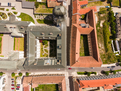 Aerial view of the historic university buildings and courtyards with red tiled roofs and green gardens in the old town of Trnava Trnava Region Slovakia. Aerial view of the historic university buildings and courtyards with red tiled roofs and green gardens in the old town of Trnava Trnava Region Slovakia.