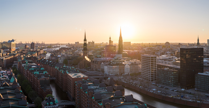Aerial view of the historic Speicherstadt warehouse district and church spires during golden hour in Hamburg Hamburg Germany. Aerial view of the historic Speicherstadt warehouse district and church spires during golden hour in Hamburg Hamburg Germany.