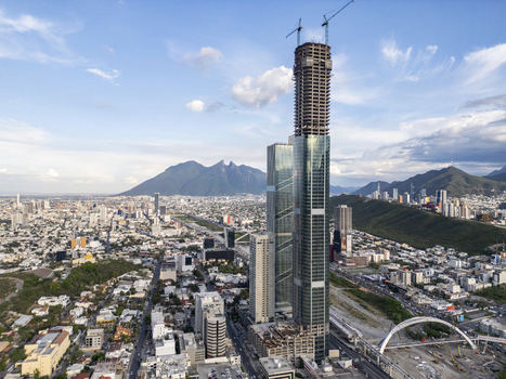 Aerial view of the Rise Tower skyscraper under construction surrounded by the urban landscape and mountains of Monterrey Nuevo Leon Mexico. Aerial view of the Rise Tower skyscraper under construction surrounded by the urban landscape and mountains of Monterrey Nuevo Leon Mexico.