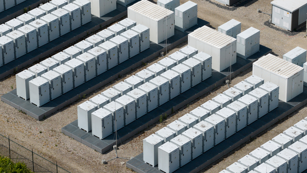 Aerial view of rows of white containerized battery energy storage units in a solar farm facility in Wanneperveen Overijssel Netherlands.