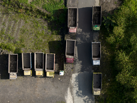 Aerial view of empty dump trucks parked at the Tambang Pasir Merapi Kali Gendol Sand Mine in Kecamatan Cangkringan Daerah Istimewa Yogya Indonesia. Aerial view of empty dump trucks parked at the Tambang Pasir Merapi Kali Gendol Sand Mine in Kecamatan Cangkringan Daerah Istimewa Yogya Indonesia.