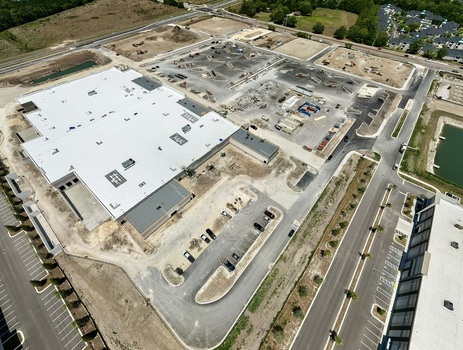 Aerial view of the large commercial building construction at Foundry Lane with parking lots and heavy machinery in World Golf Village Florida United States.