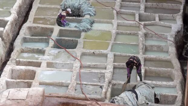 View of workers at Chouara Tannery in Fes Morocco.