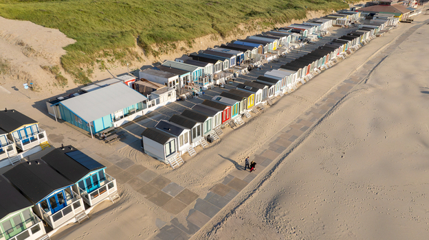 Aerial view of Strand Wijk aan Zee beach huts lined up along the sandy coast and grassy dunes Wijk aan Zee North Holland Netherlands. Aerial view of Strand Wijk aan Zee beach huts lined up along the sandy coast and grassy dunes Wijk aan Zee North Holland Netherlands.