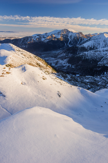 View of the snow covered slopes of Ornak in the Western Tatras under a clear blue sky in Tatra County Lesser Poland Voivode Poland. View of the snow covered slopes of Ornak in the Western Tatras under a clear blue sky in Tatra County Lesser Poland Voivode Poland.