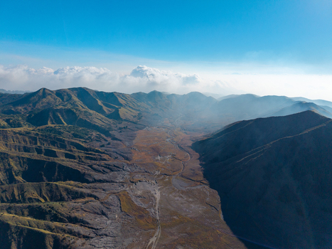 Aerial view of the volcanic landscape of the Tengger Caldera near the mountain ridges and valleys of Kecamatan Tosari Jawa Timur Indonesia. Aerial view of the volcanic landscape of the Tengger Caldera near the mountain ridges and valleys of Kecamatan Tosari Jawa Timur Indonesia.