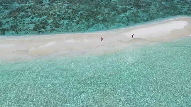 Aerial view of people walking on a tropical sandbank Maldives. Aerial view of people walking on a tropical sandbank Maldives.