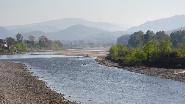 View of a wide river flowing through a valley Nepal.