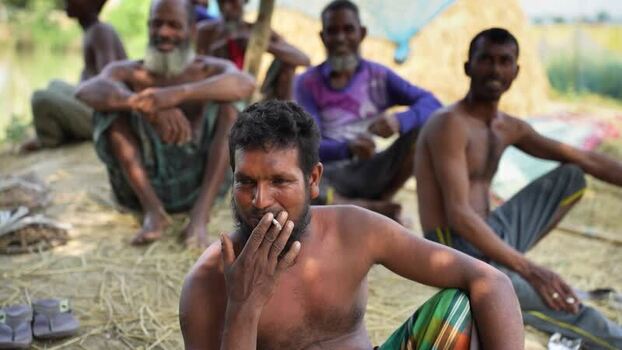 View of men sitting outdoors and smoking Bangladesh. View of men sitting outdoors and smoking Bangladesh.