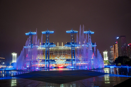 Guangzhou Guangdong Province China 24 February 2024 View of the illuminated fountain show at Haixinsha Asian Games Park with water jets and blue lights against the night. Guangzhou Guangdong Province China 24 February 2024 View of the illuminated fountain show at Haixinsha Asian Games Park with water jets and blue lights against the night.