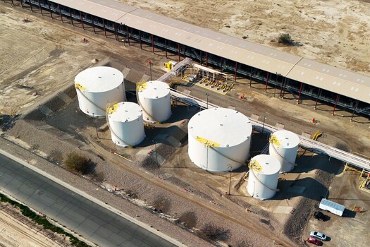 Grand Junction Colorado United States 03 July 2026 Aerial view of storage tanks at an industrial facility with a long warehouse building and paved road nearby. Grand Junction Colorado United States 03 July 2026 Aerial view of storage tanks at an industrial facility with a long warehouse building and paved road nearby.