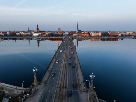Aerial view of Akmens tilts bridge crossing the Daugava River towards the historic skyline of Riga Latvia. Aerial view of Akmens tilts bridge crossing the Daugava River towards the historic skyline of Riga Latvia.